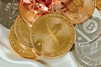 a pile of bitcoins sitting on top of a white cloth