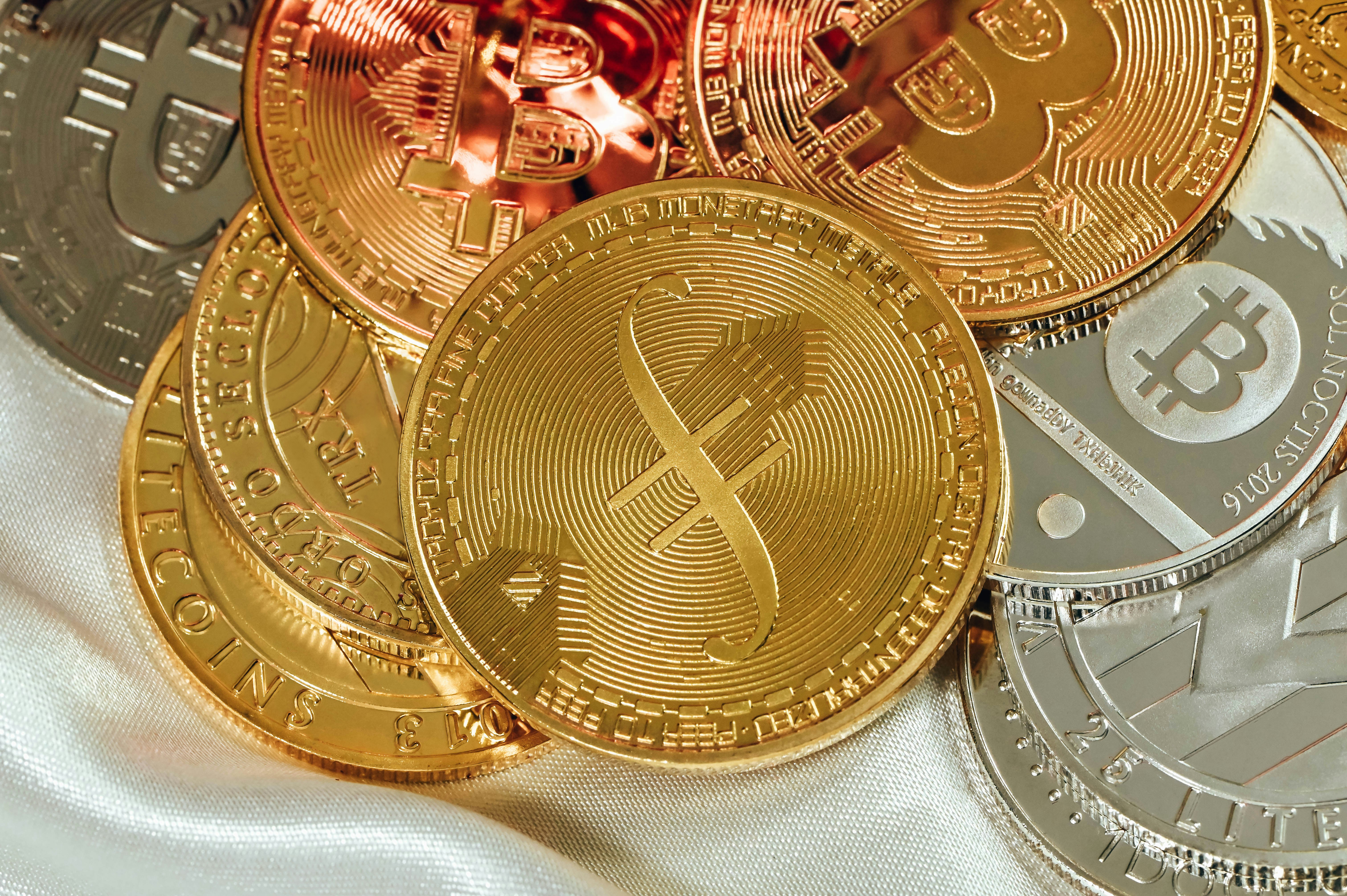 A variety of cryptocurrencies on a white fabric