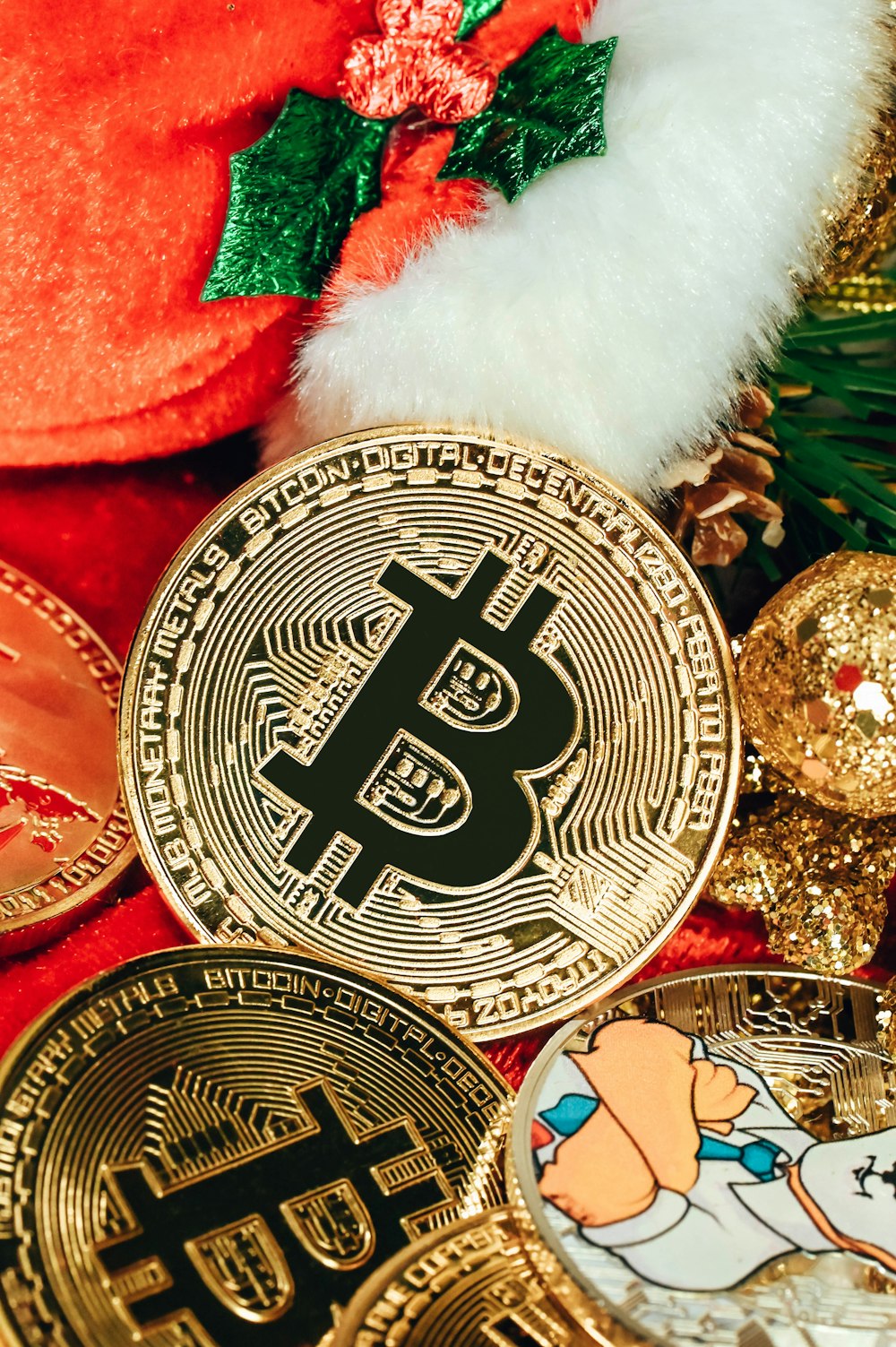 a pile of bitcoins sitting next to a christmas tree