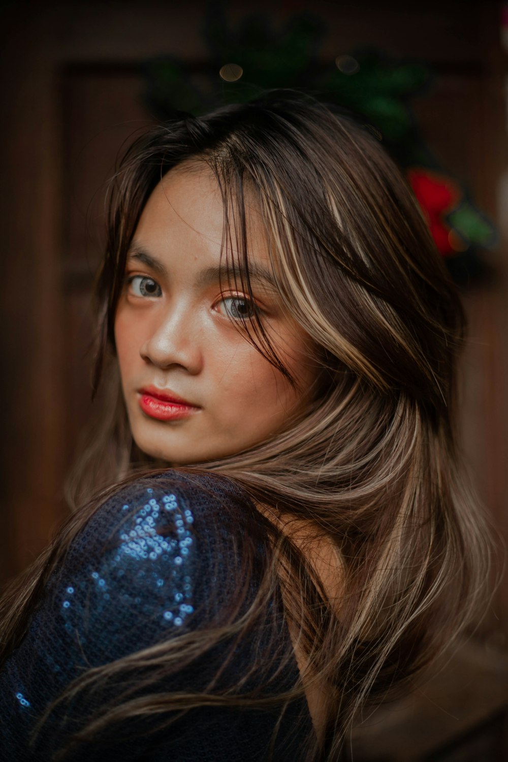 a woman with long hair and a blue dress