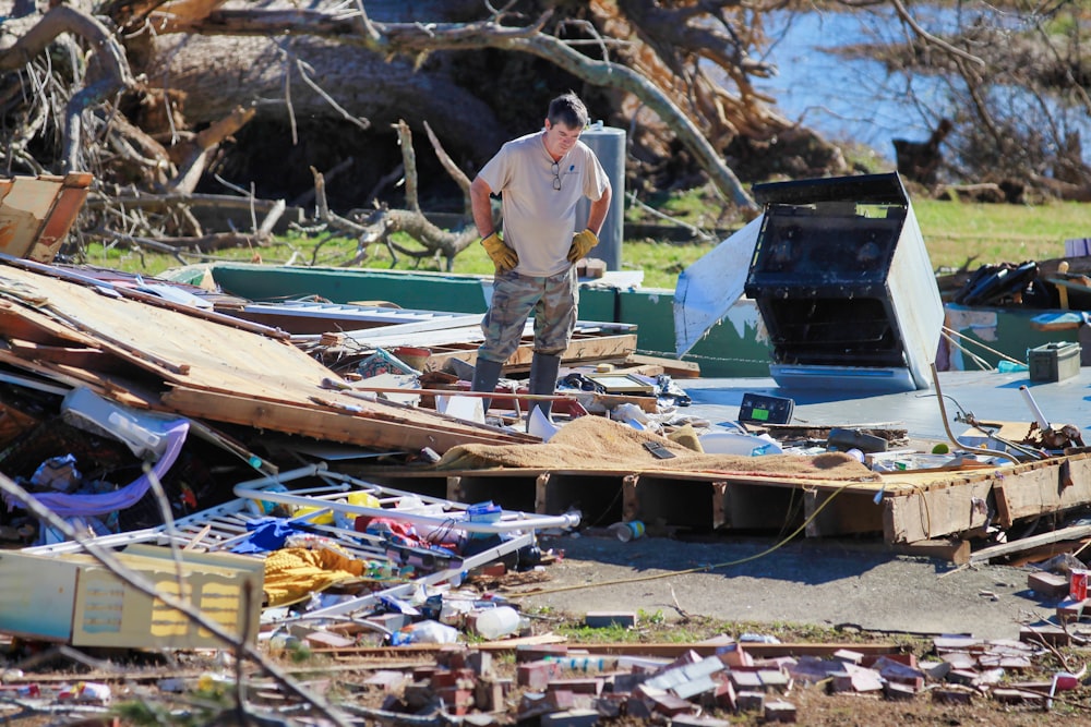 a man standing on top of a pile of junk