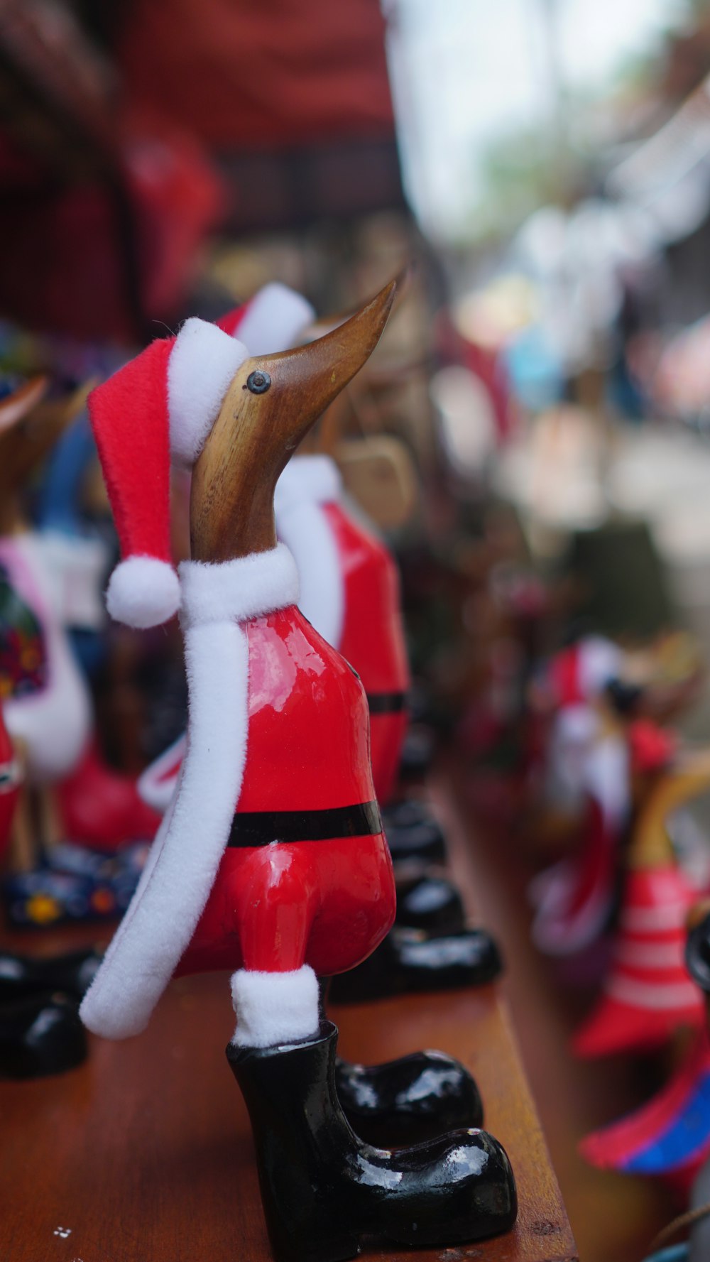 a close up of a figurine of a duck wearing a santa suit