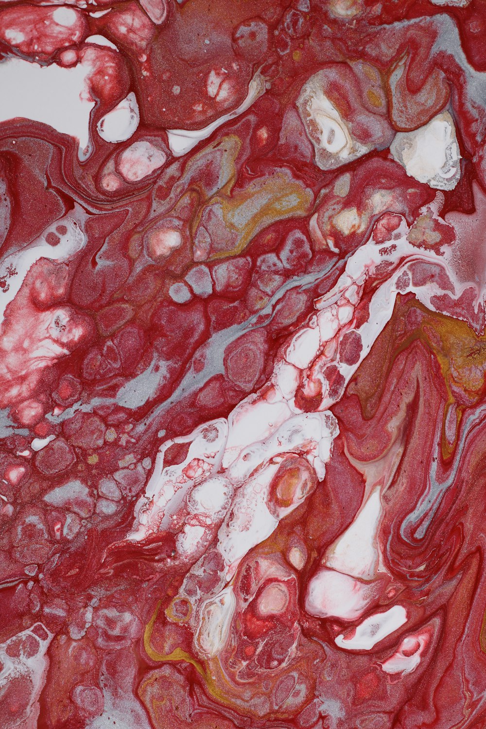 a close up of a red and white marble