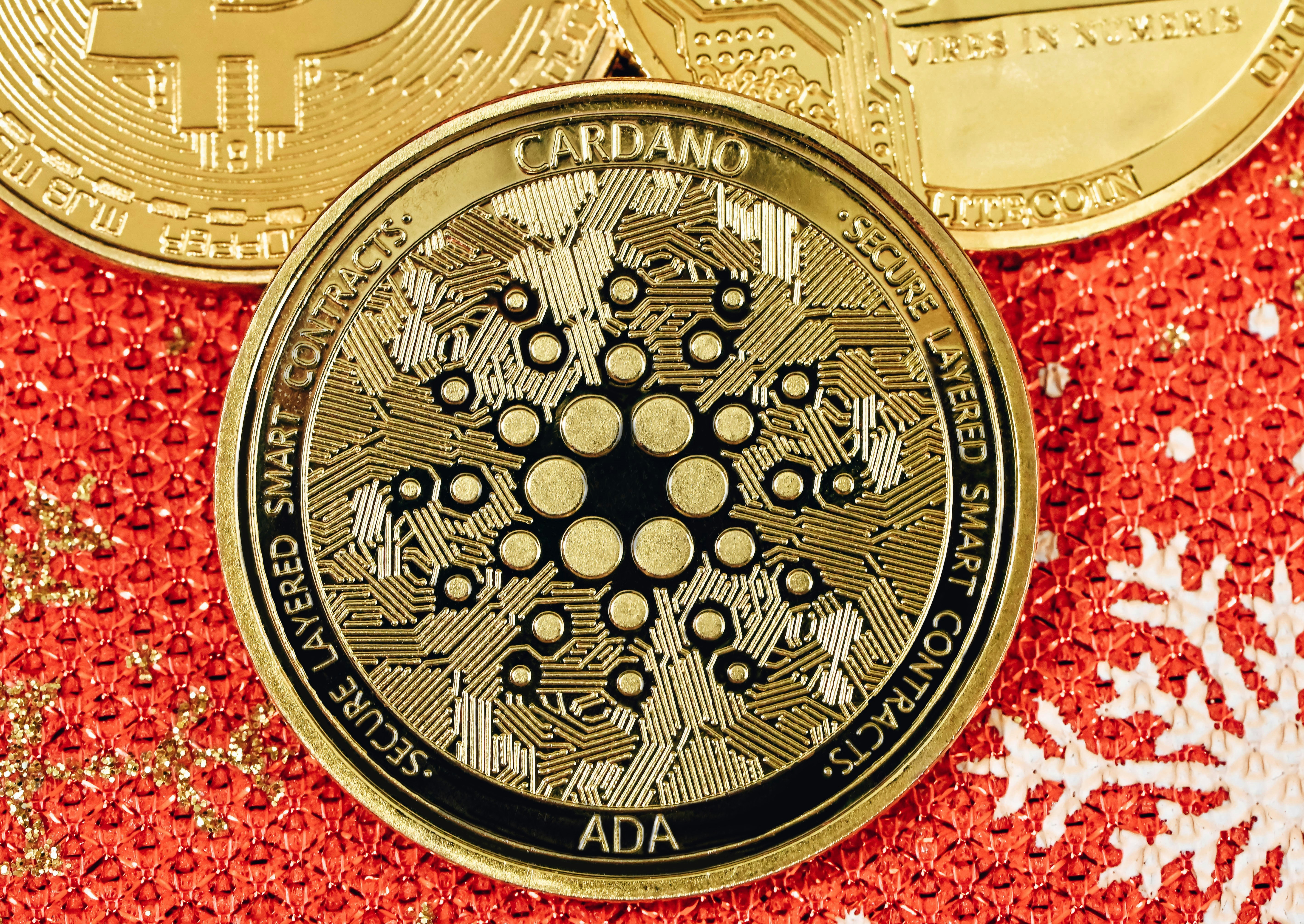 An ADA coin on top of a red Christmas background