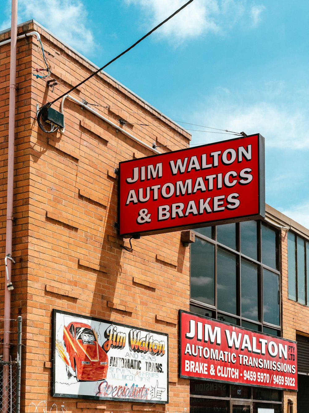 a red sign hanging from the side of a building