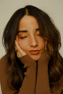 a woman with her hands on her face