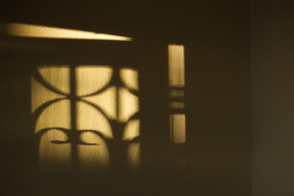 a shadow of a window on a wall