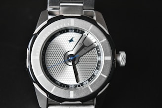 a close up of a watch on a black surface