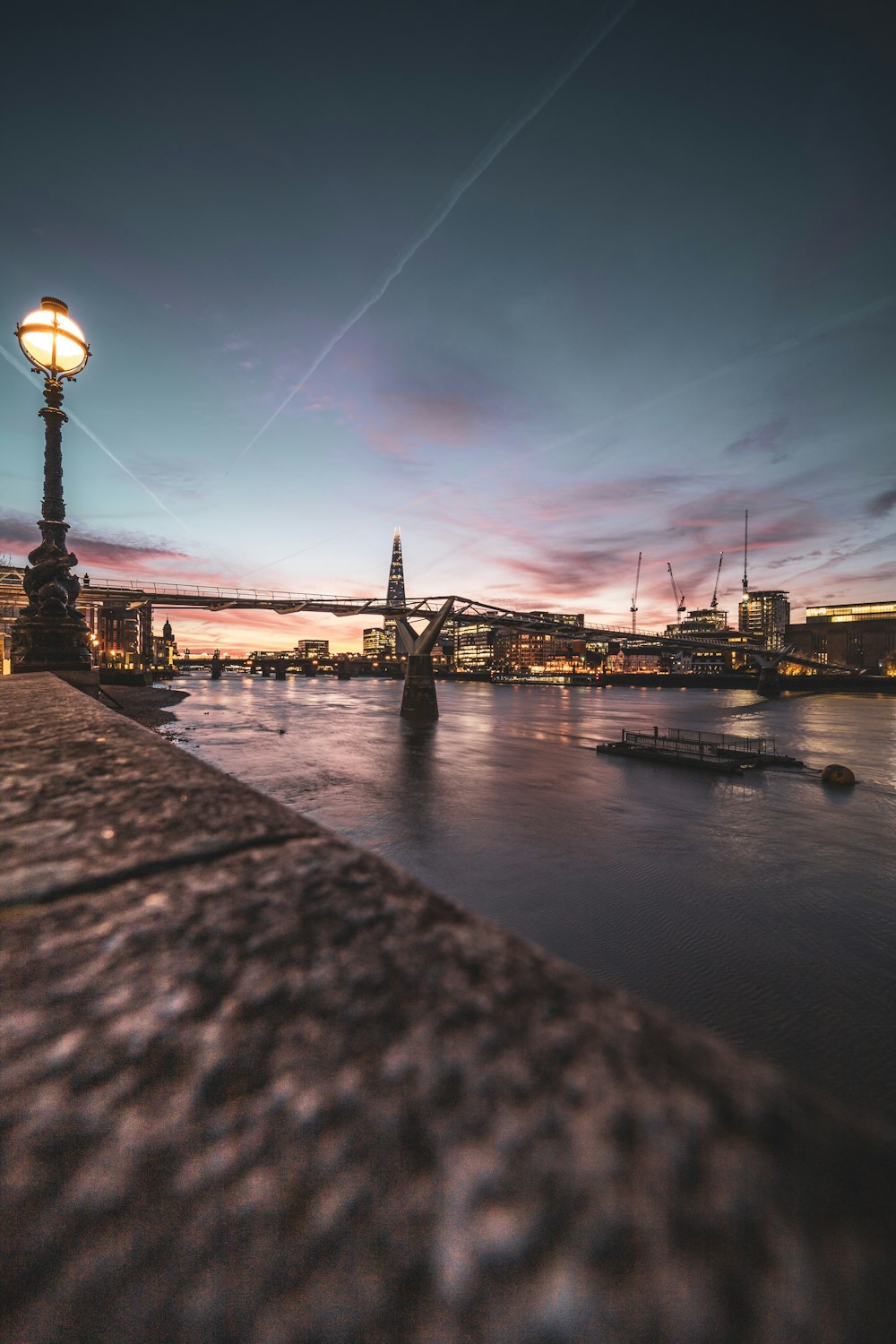 a view of a river with a bridge in the background