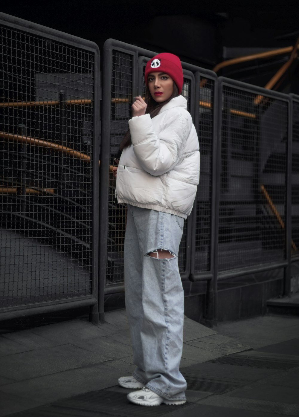 a woman in a white jacket and a red hat