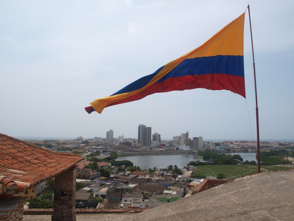 a flag flying in the wind over a city