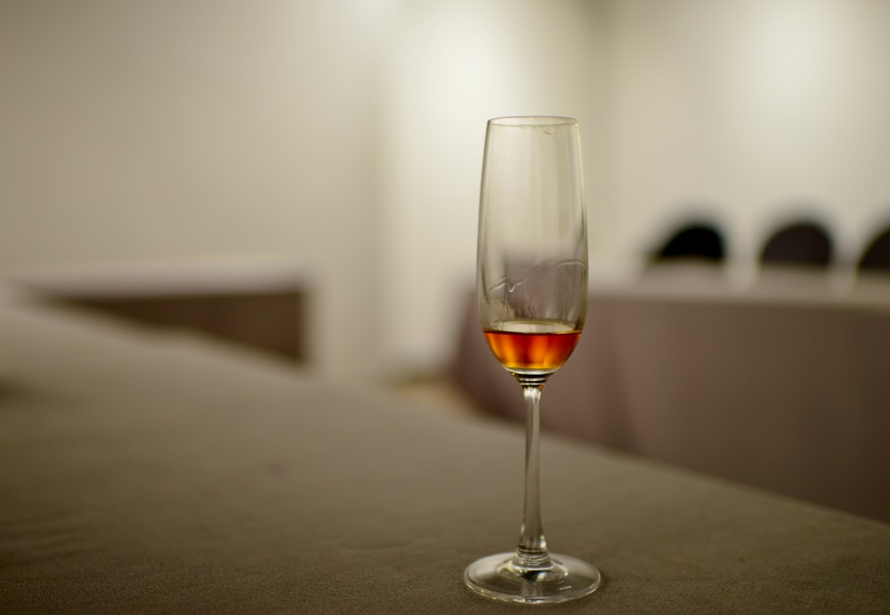 a glass of wine sitting on top of a table