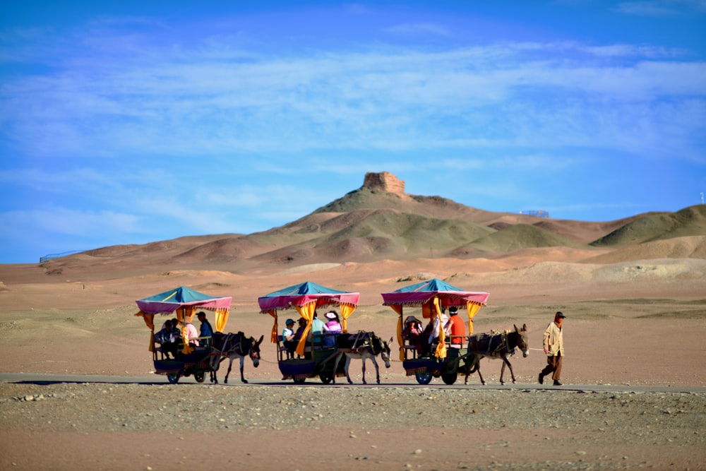 a group of people riding on the back of a horse drawn carriage