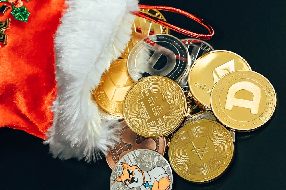 a pile of bitcoins sitting next to a santa hat