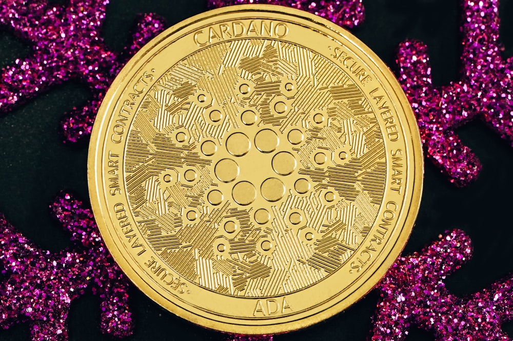 a gold coin sitting on top of purple glitter