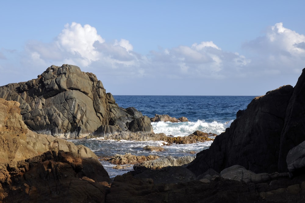 a large rock outcropping in the middle of the ocean