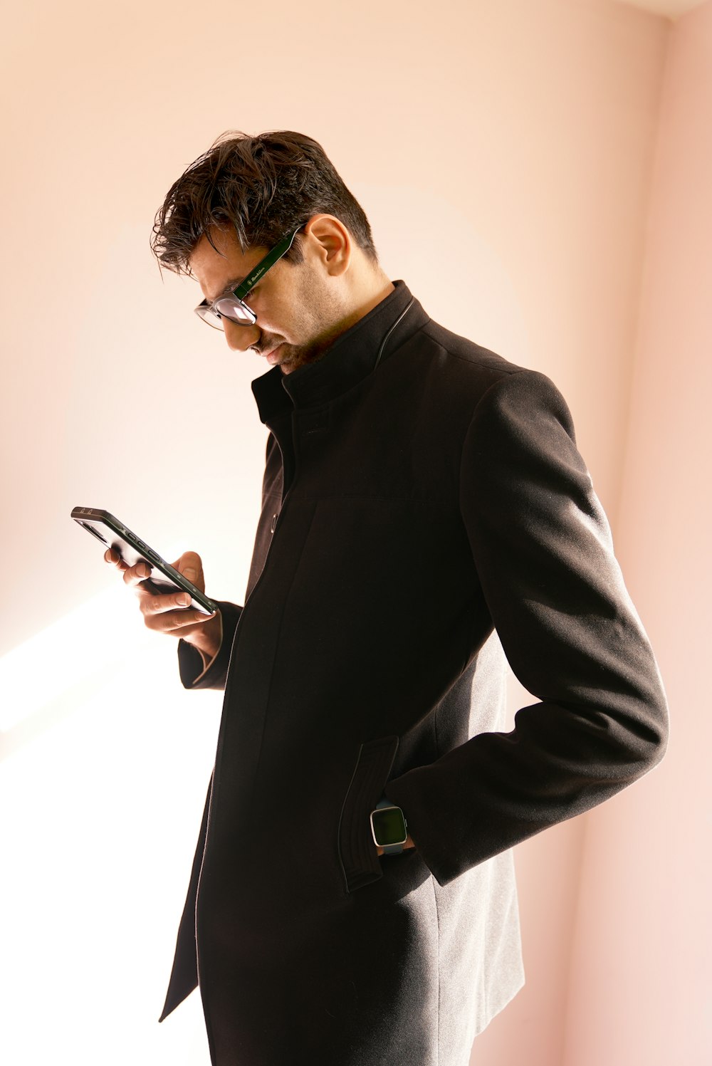 a man in a suit looking at his cell phone