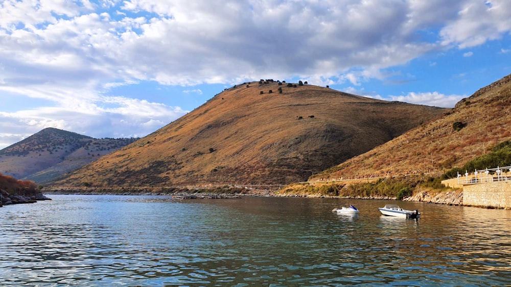 a couple of boats floating on top of a lake