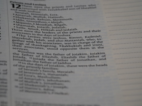 A close-up photograph of a page from a book, showing text that lists names and their roles in a religious or historical context. The page includes formatting with lines to the right side.