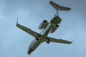 a large jetliner flying through a cloudy blue sky