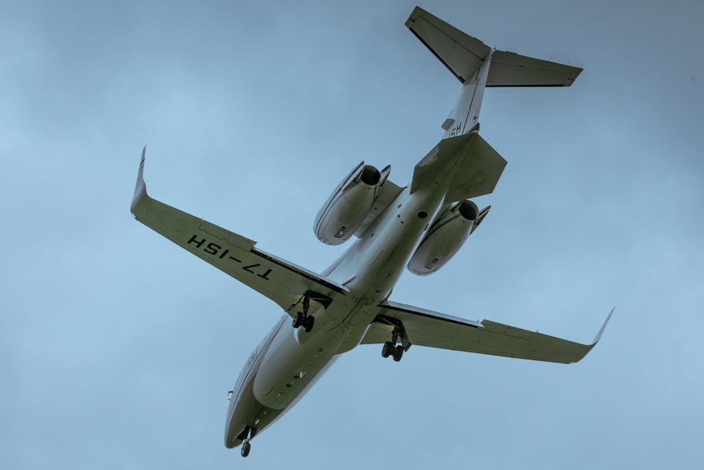 a large jetliner flying through a cloudy blue sky