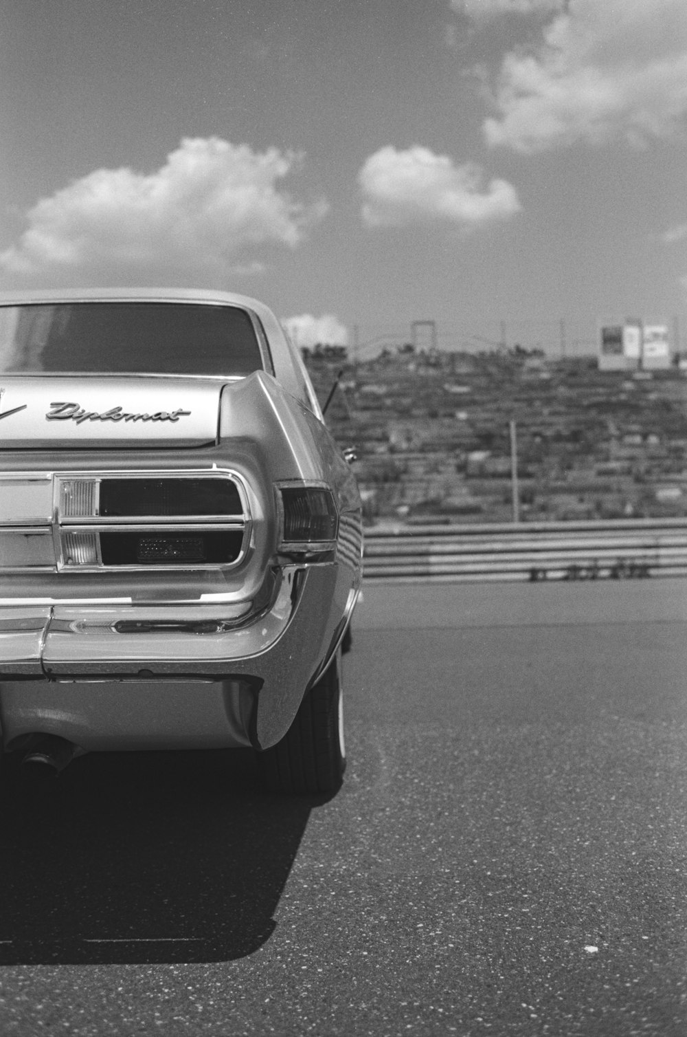 a black and white photo of a car on a track