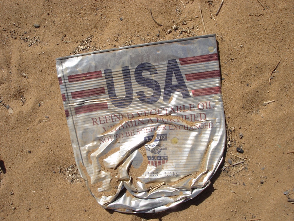 a piece of luggage sitting on top of a sandy beach