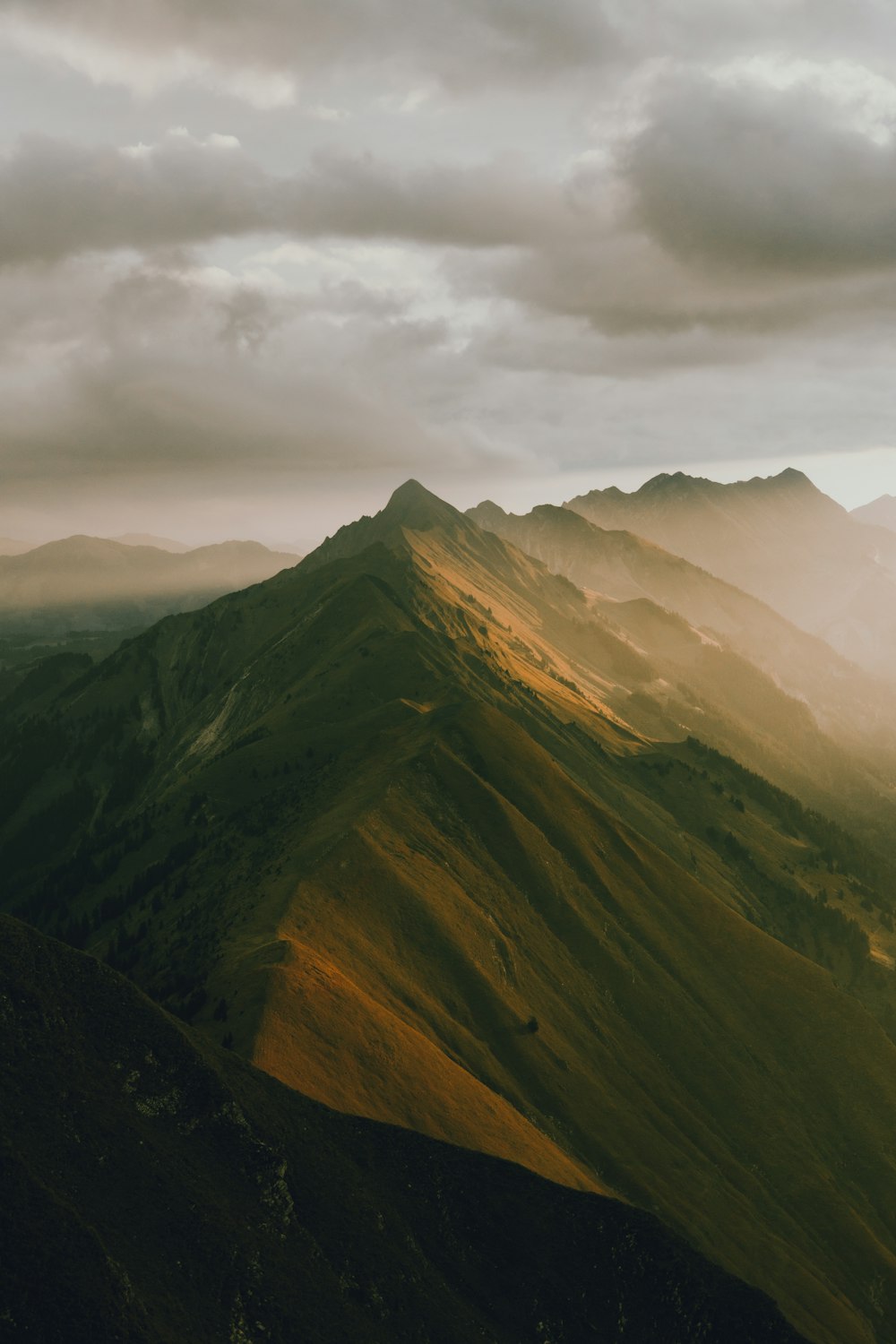 a view of a mountain range with a cloudy sky