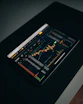 Close-up of hands analyzing charts and graphs on a tablet for investment growth.