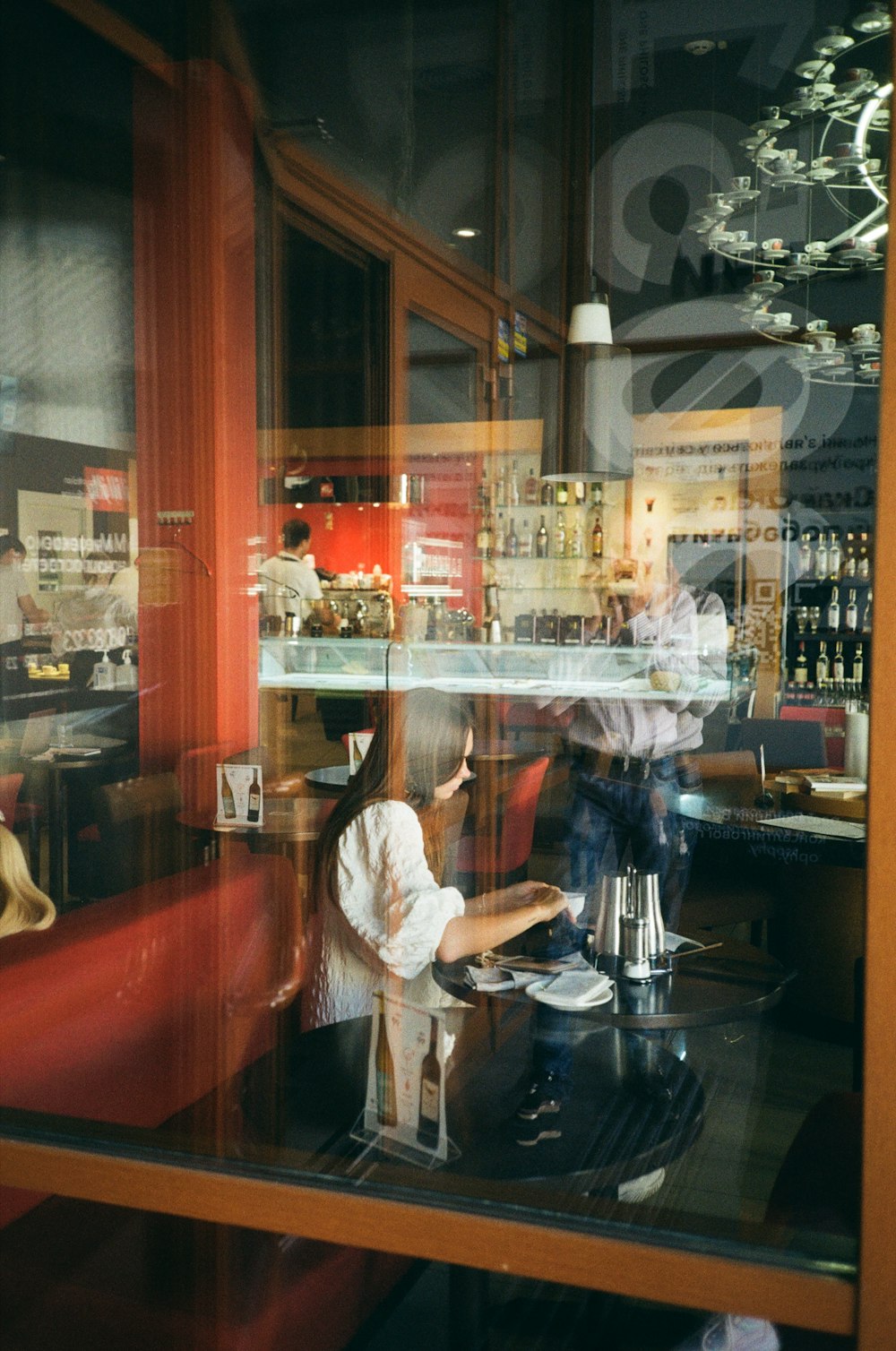 a woman sitting at a table in a restaurant