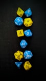 a group of blue and yellow dice sitting on top of a table