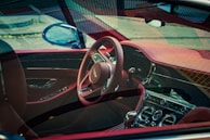 the interior of a car with a steering wheel and dashboard