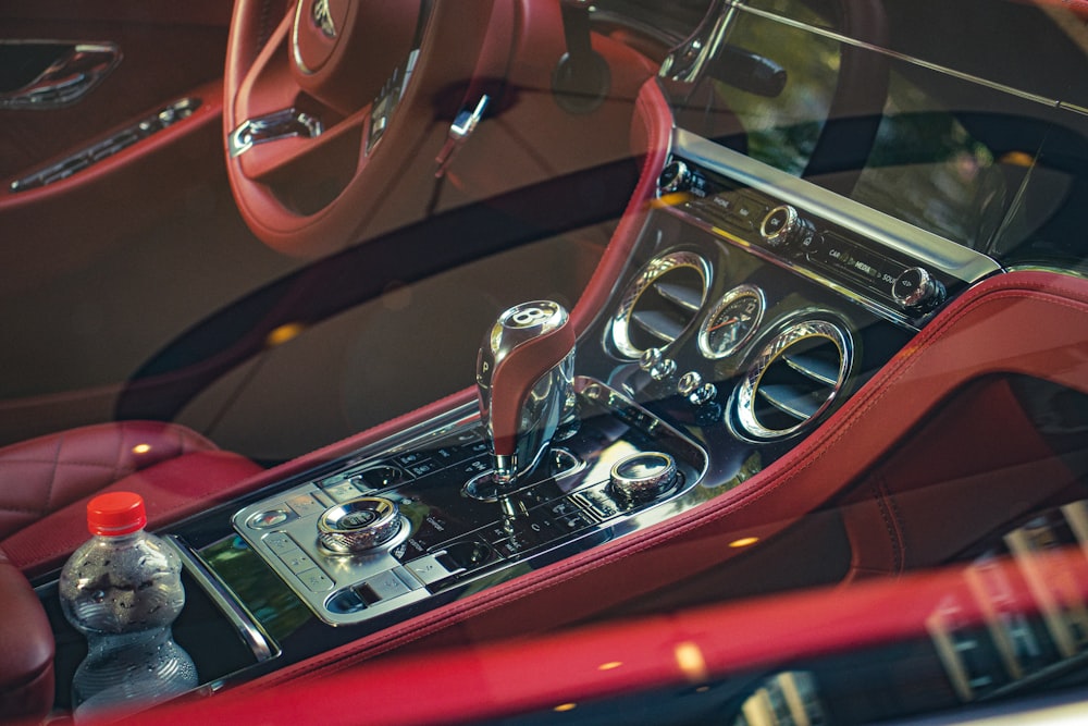 the interior of a car with a red leather dash board