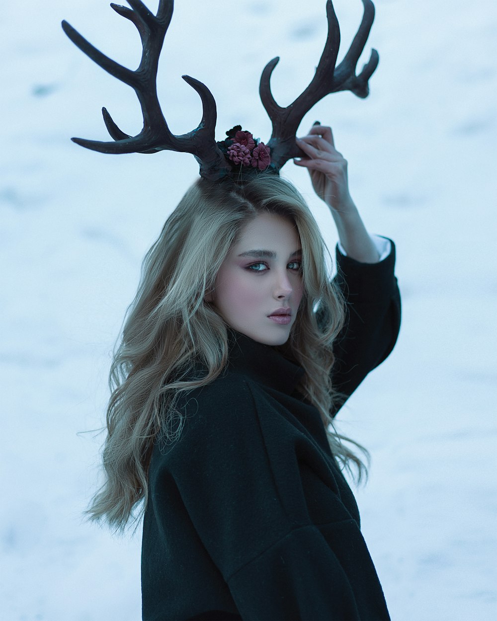 a woman with a deer's antlers on her head