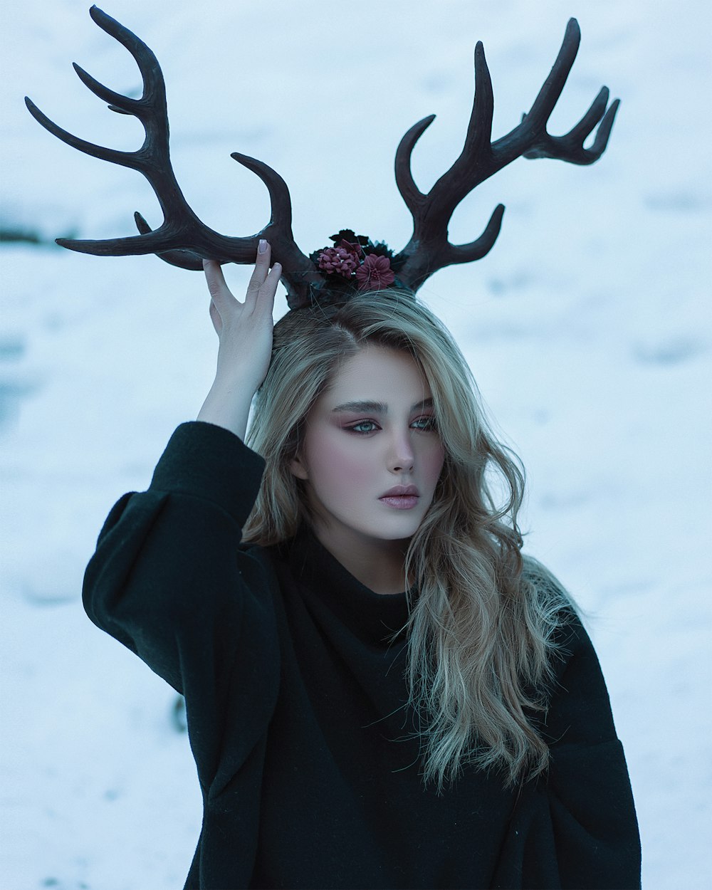 a woman with a deer's antlers on her head