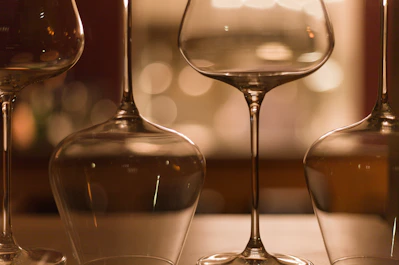 Close-up of elegant wine glasses catching the light on a wooden table