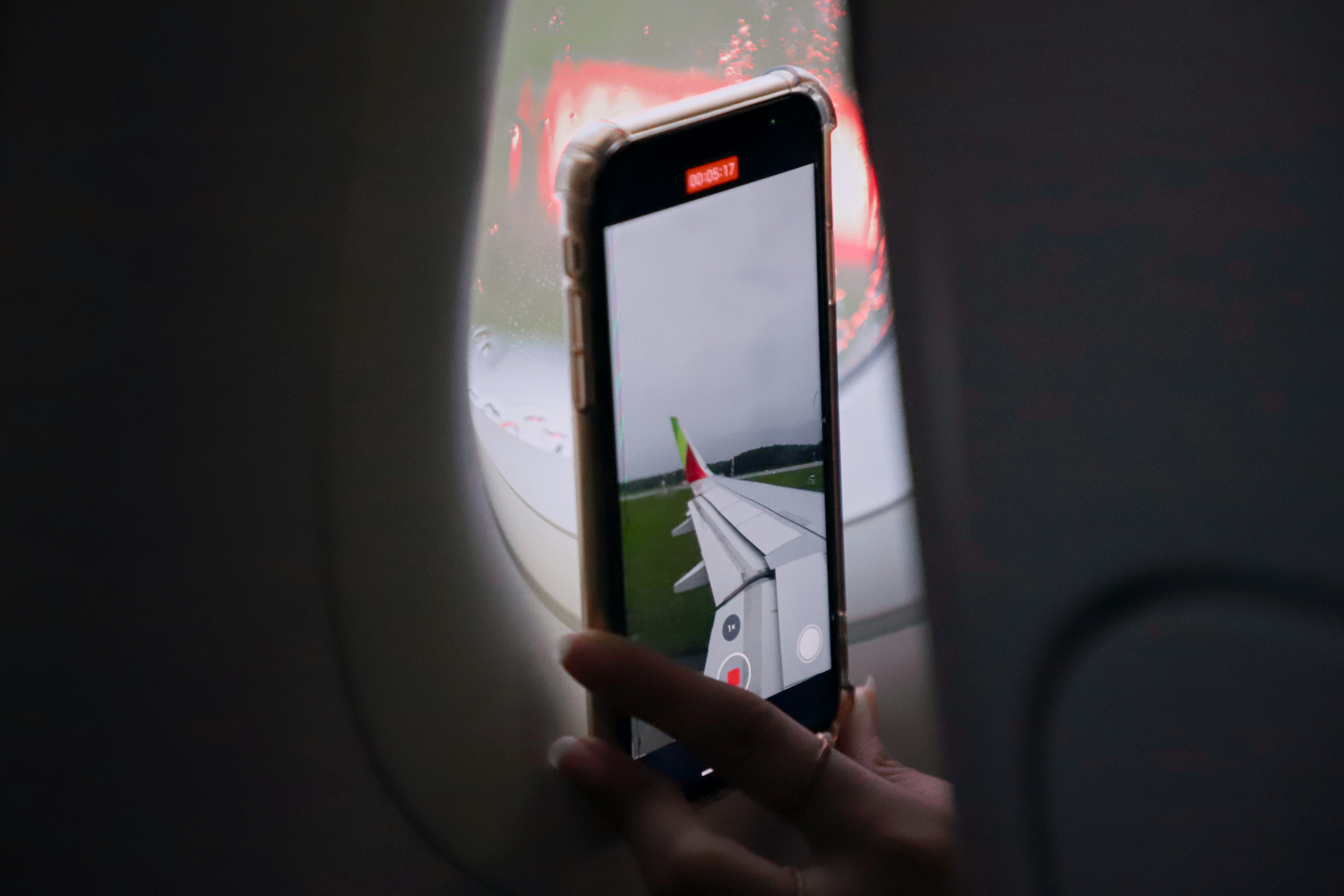 a person taking a picture of an airplane, 