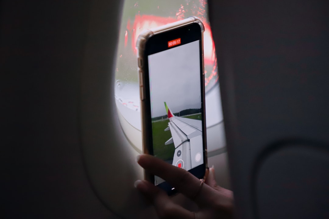 a person taking a picture of an airplane,