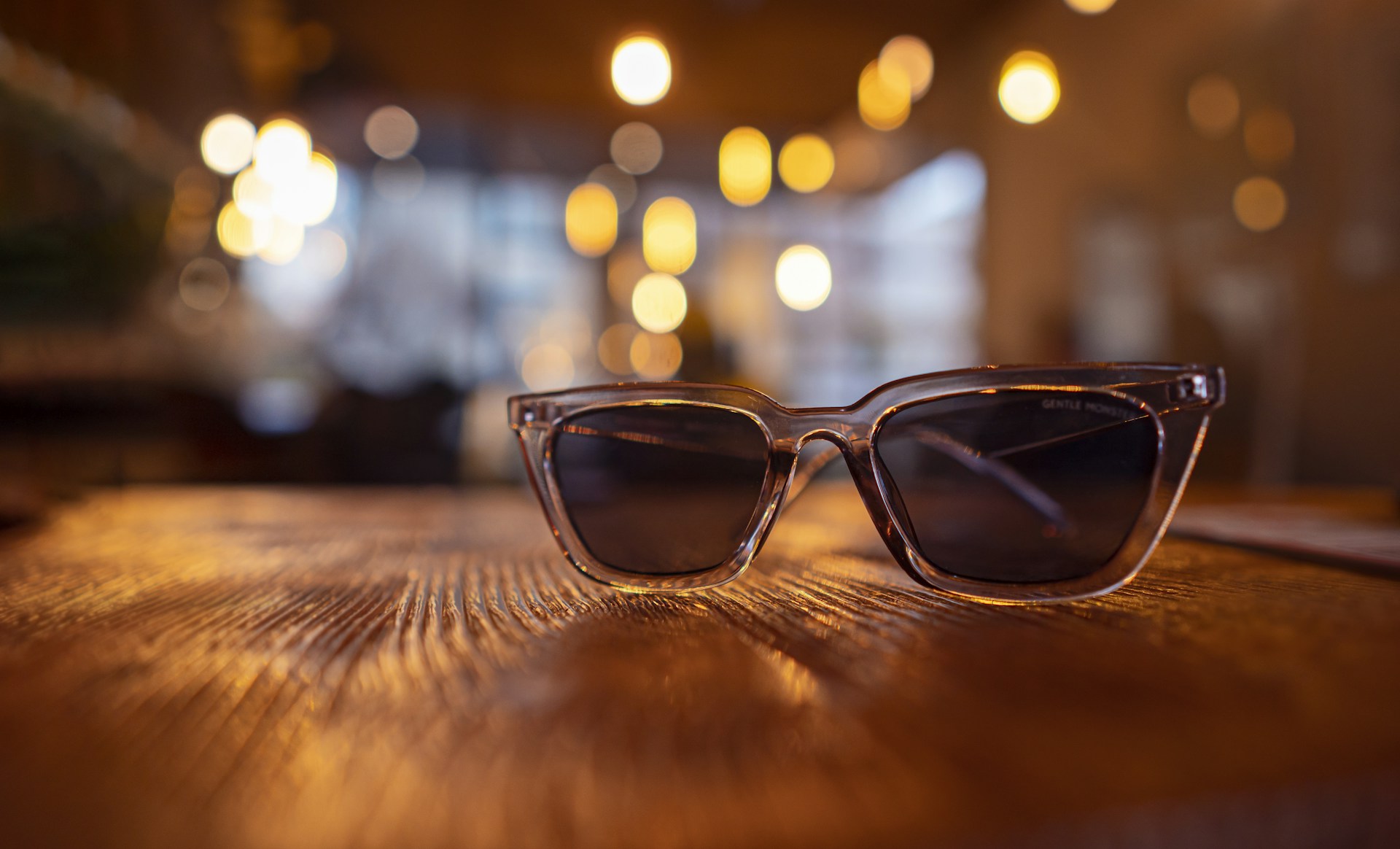 a pair of sunglasses sitting on top of a wooden table