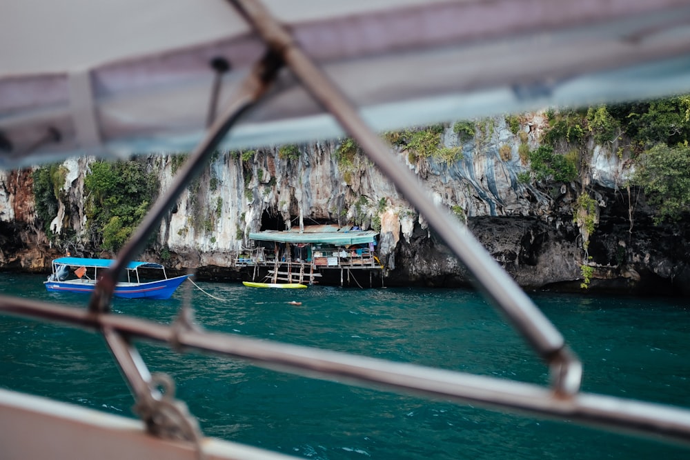 a blue boat floating on top of a body of water