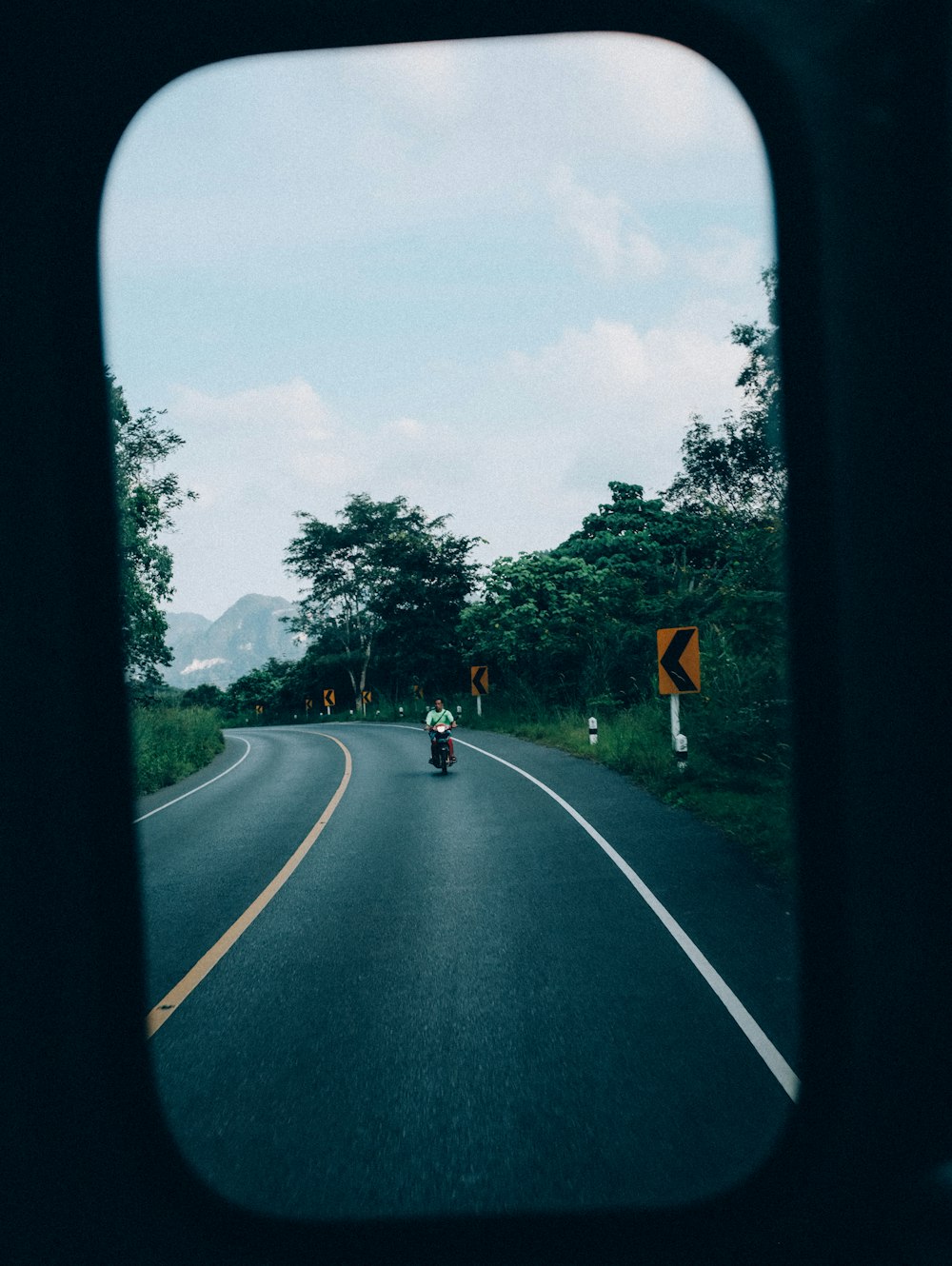 a person riding a motorcycle down a curvy road