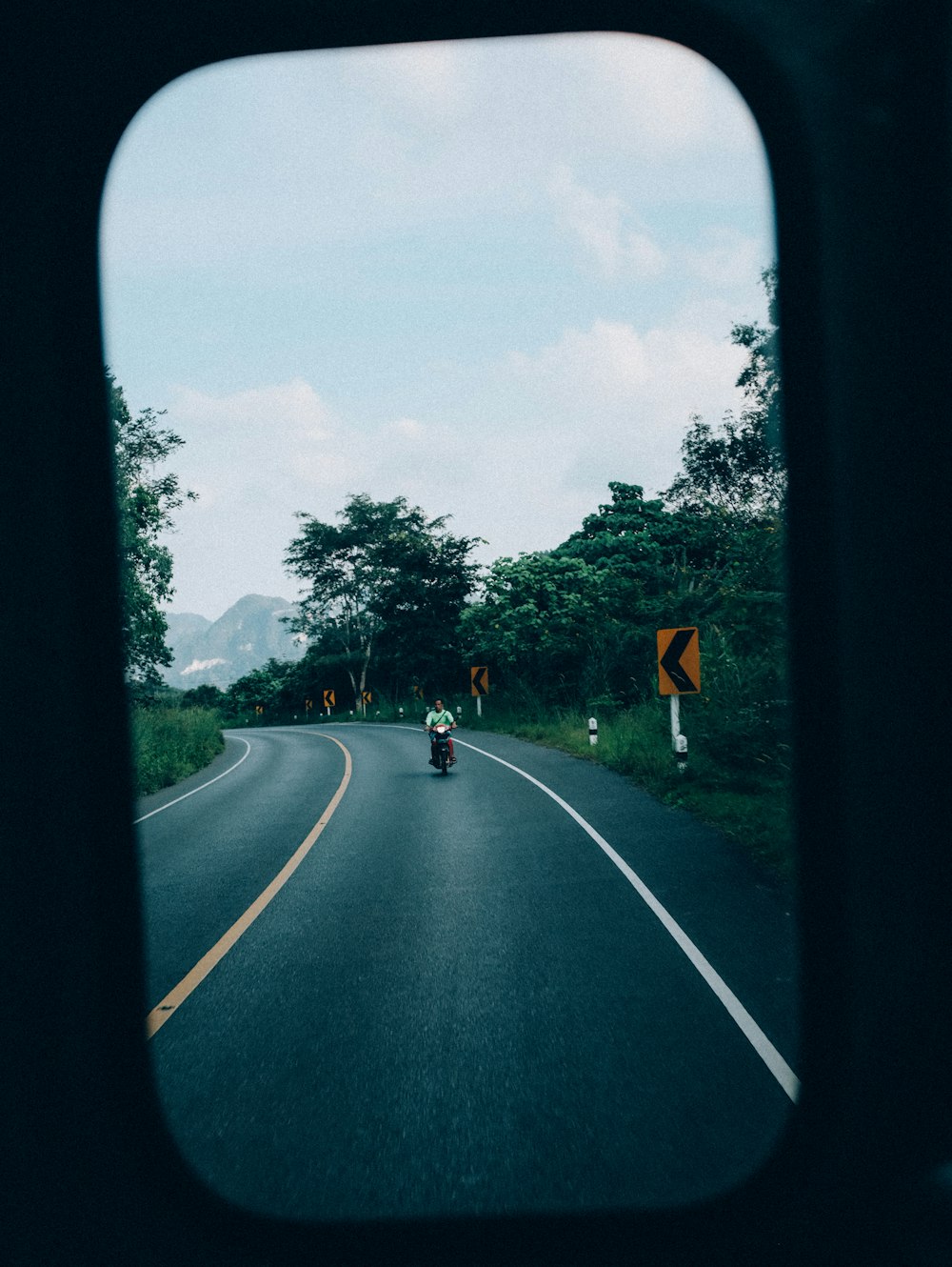 uma pessoa andando de moto por uma estrada sinuosa