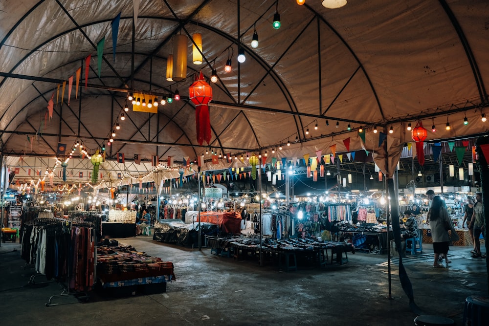 a large tent with lots of lights hanging from it's ceiling