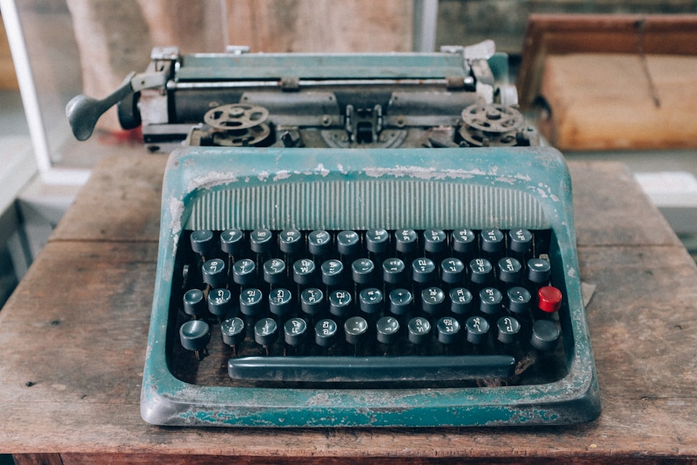 an old fashioned typewriter sitting on a wooden table