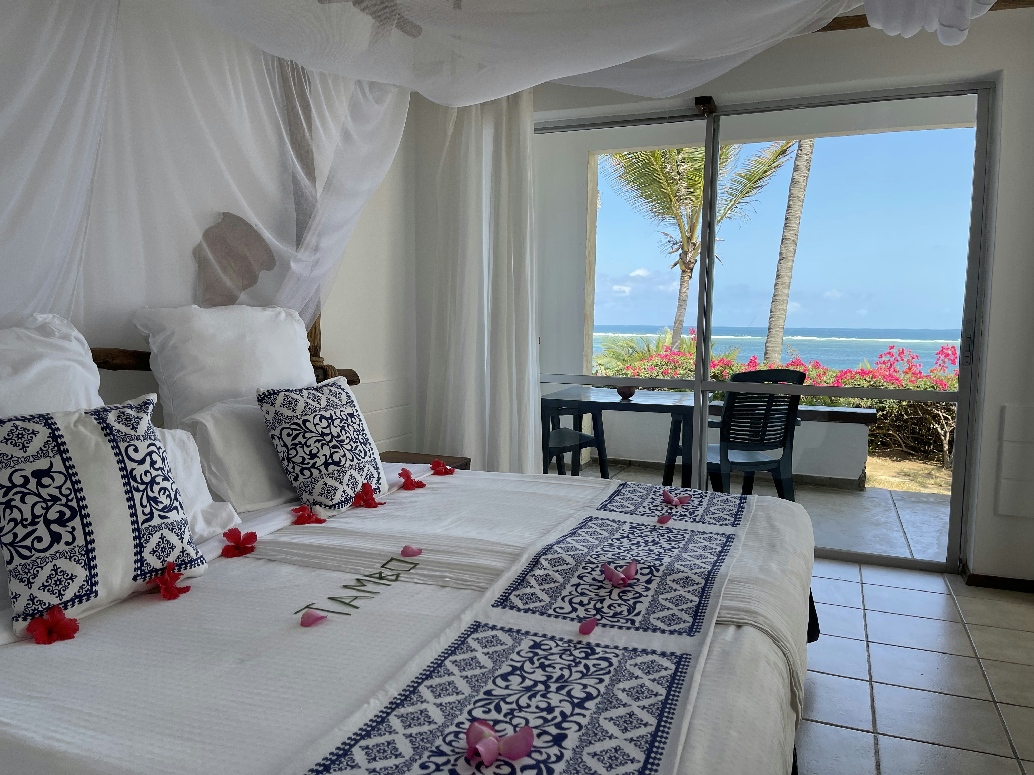 a bedroom with a bed and a view of the ocean