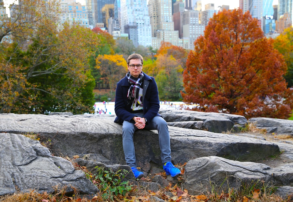 a man sitting on a rock