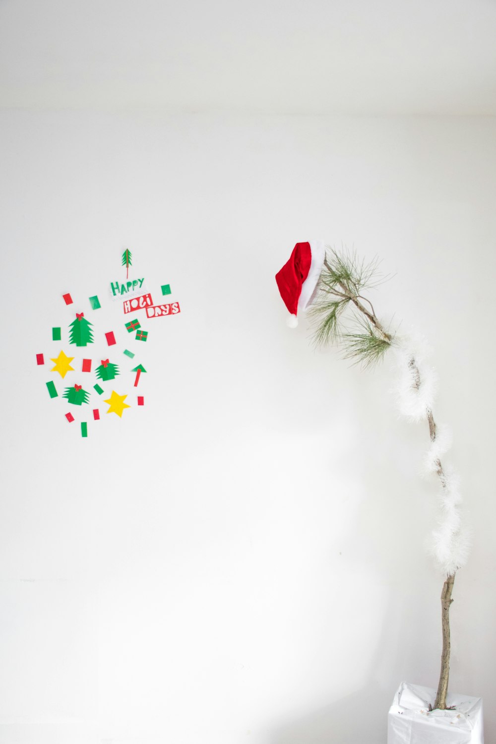 a white wall with a christmas tree on it