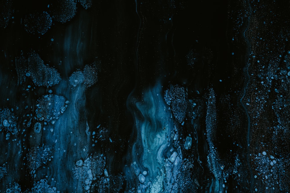 a black and blue background with water drops