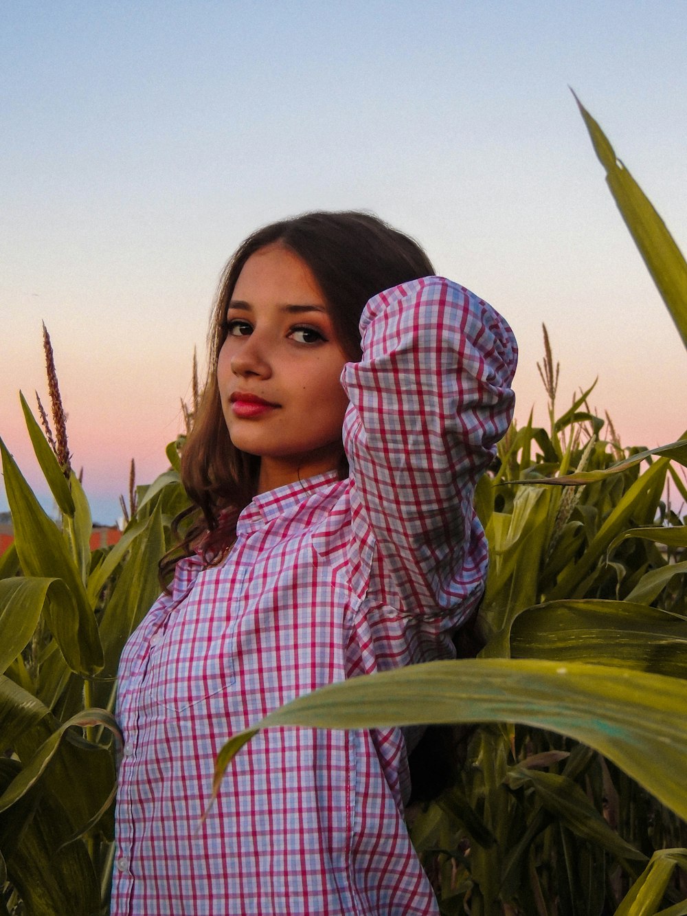 a woman standing in a field of corn