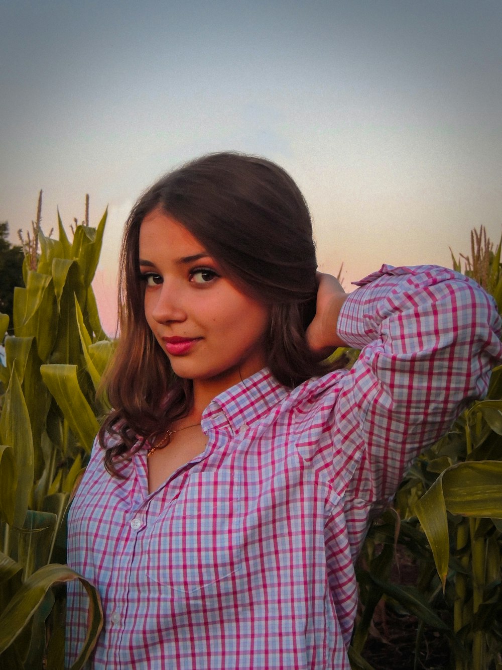 a woman standing in a field of corn